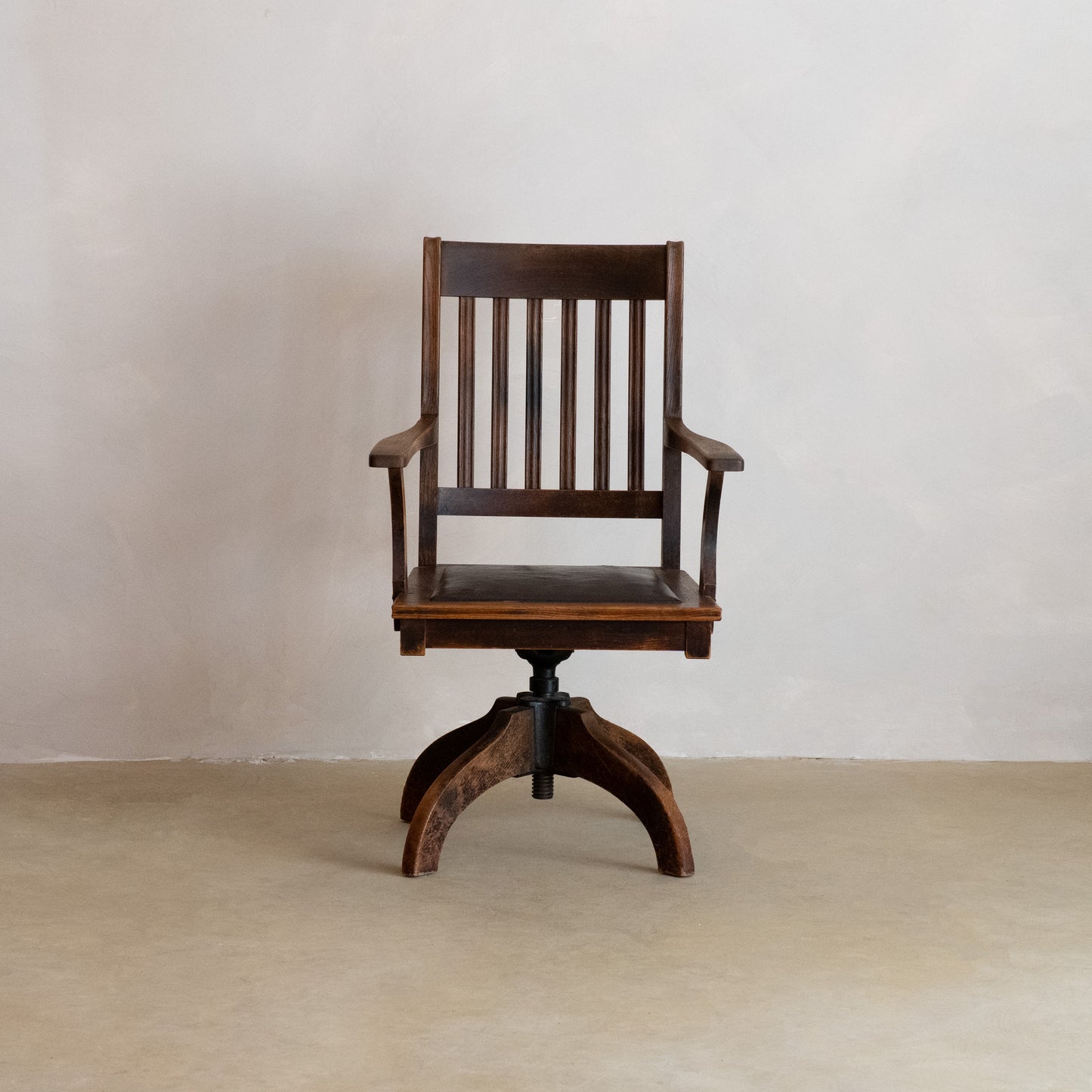 SILLÓN DE OFICINA GIRATORIO AMERICANO DE ROBLE CON ASIENTO DE CUERO, CIRCA 1900